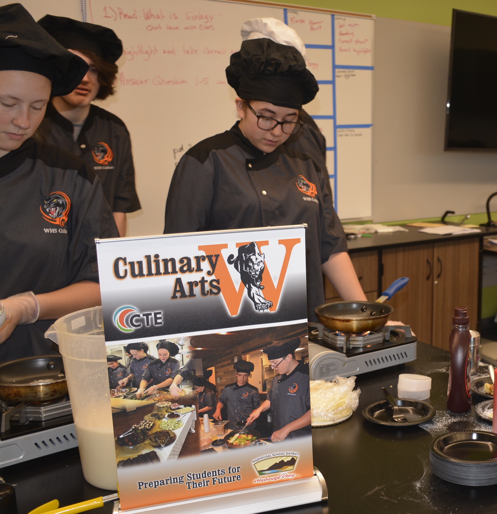 Students from Washougal High talk about the WHS Culinary program, wearing chef hats