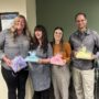 Teachers pose with gifts in honor of appreciation week
