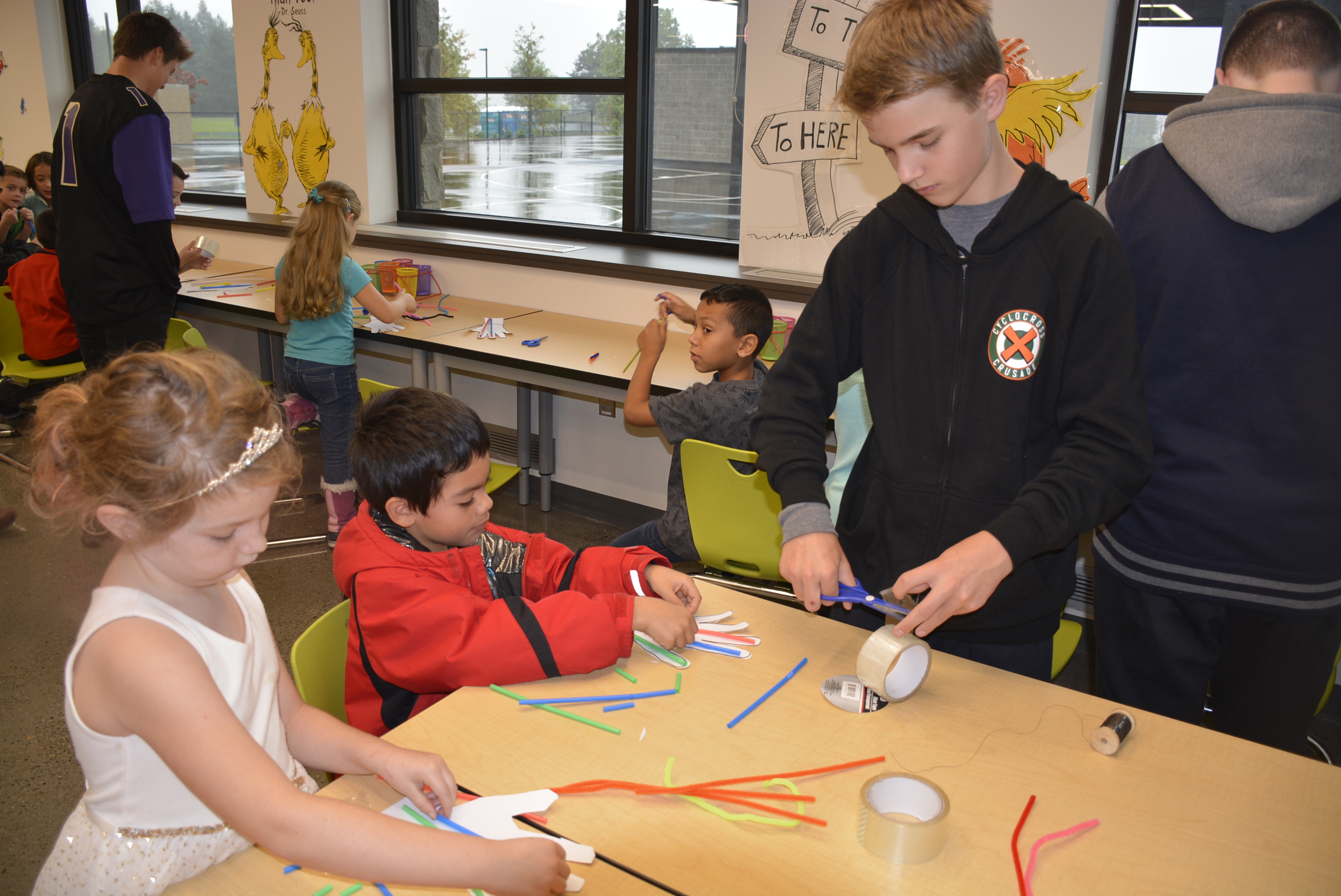 Middle school student helps younger student with project
