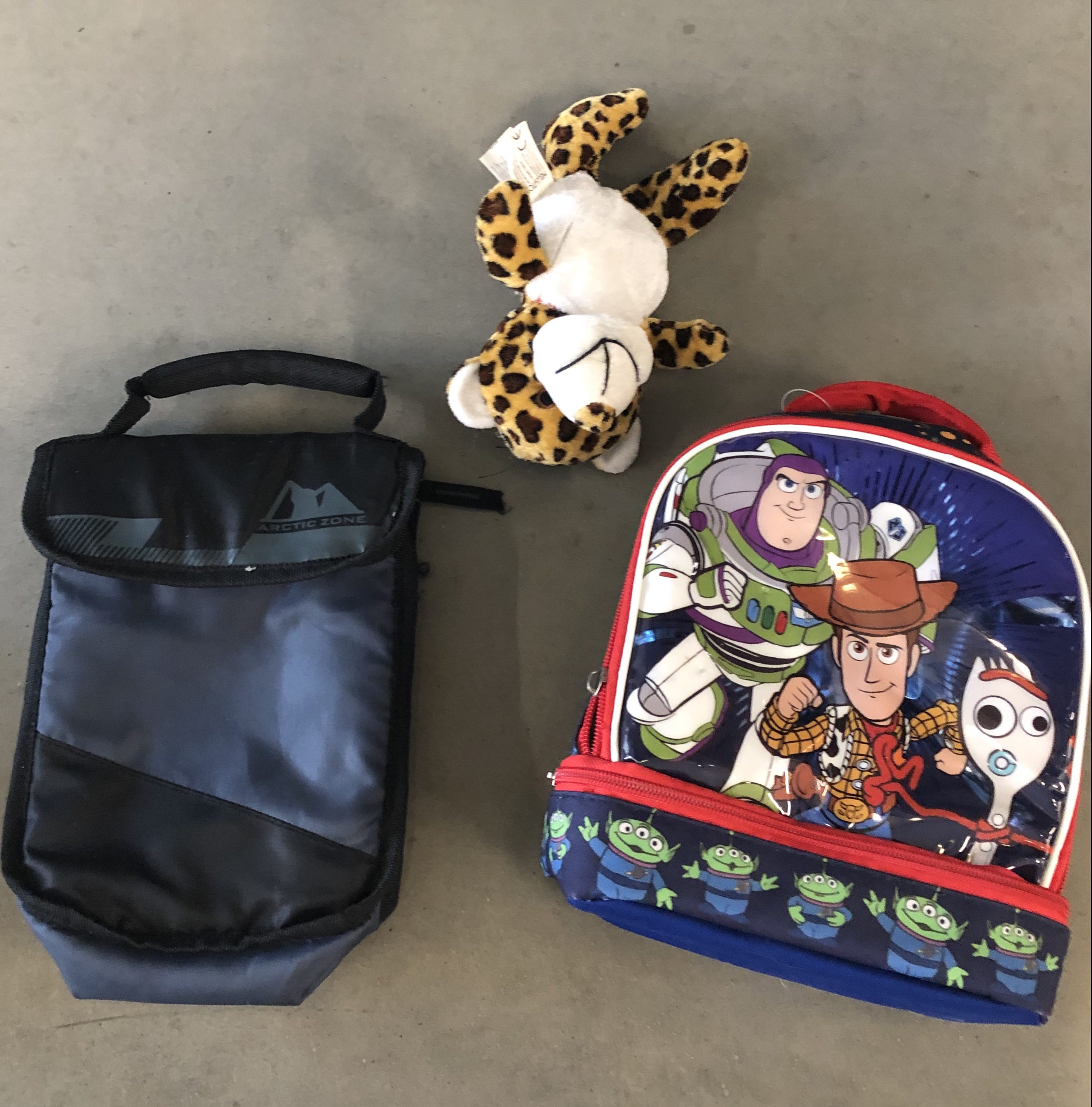 Black lunchbox, stuffed animal, Toy Story lunchbox
