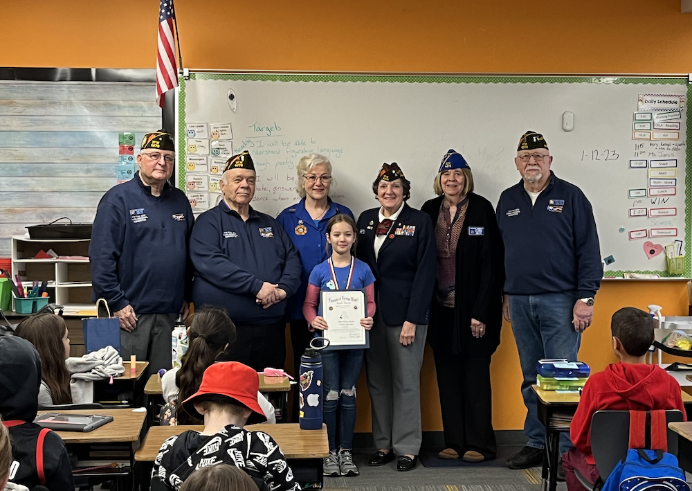 VFW members pose with student to present award