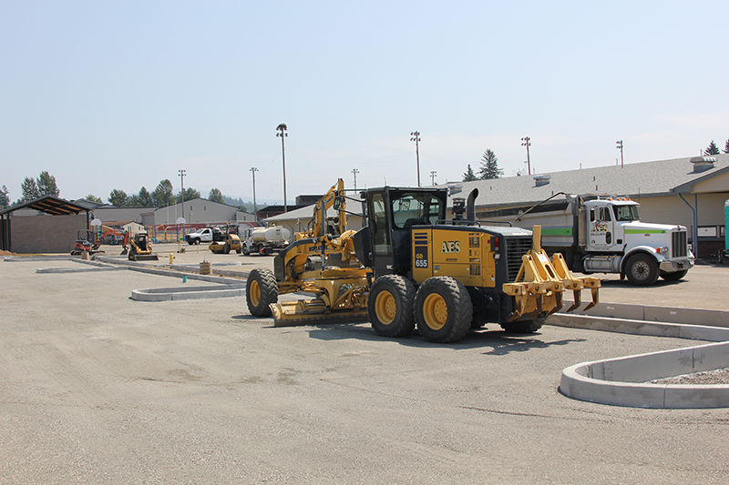 Grader in north parking lot flattening surface for paving