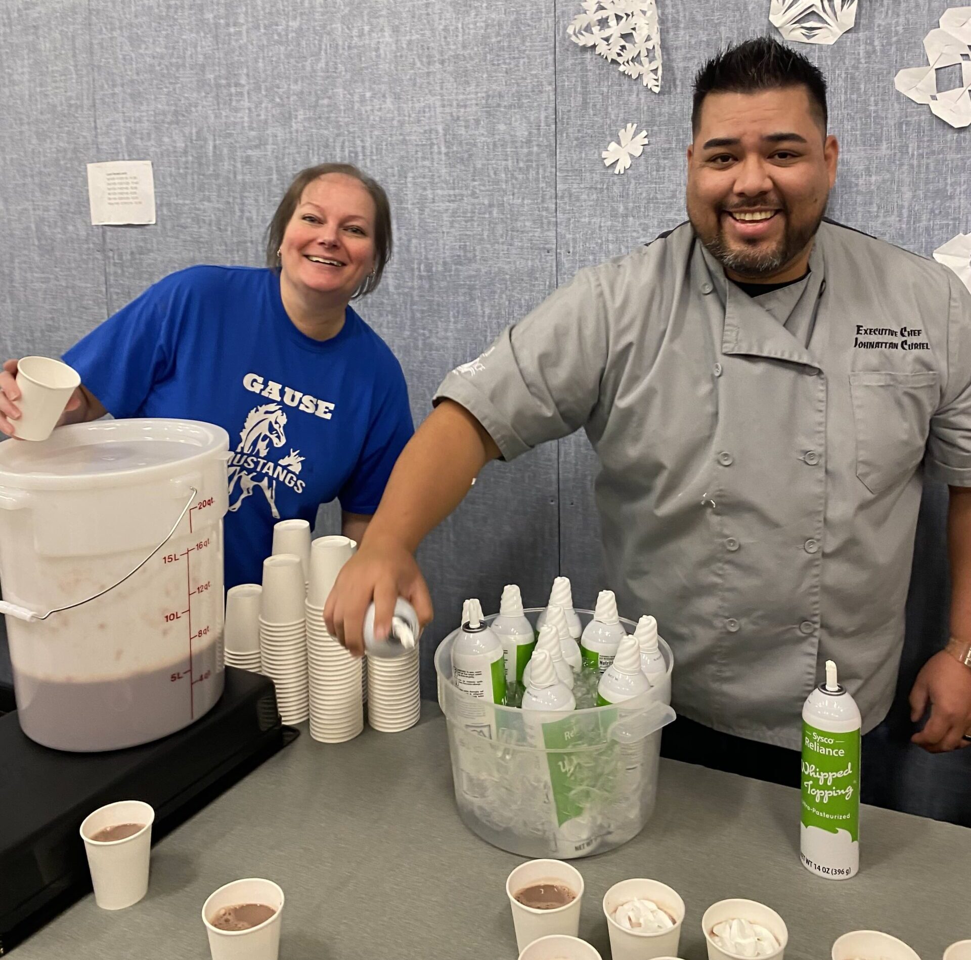 Student and parent enjoy cocoa together in the Gause cafeteria