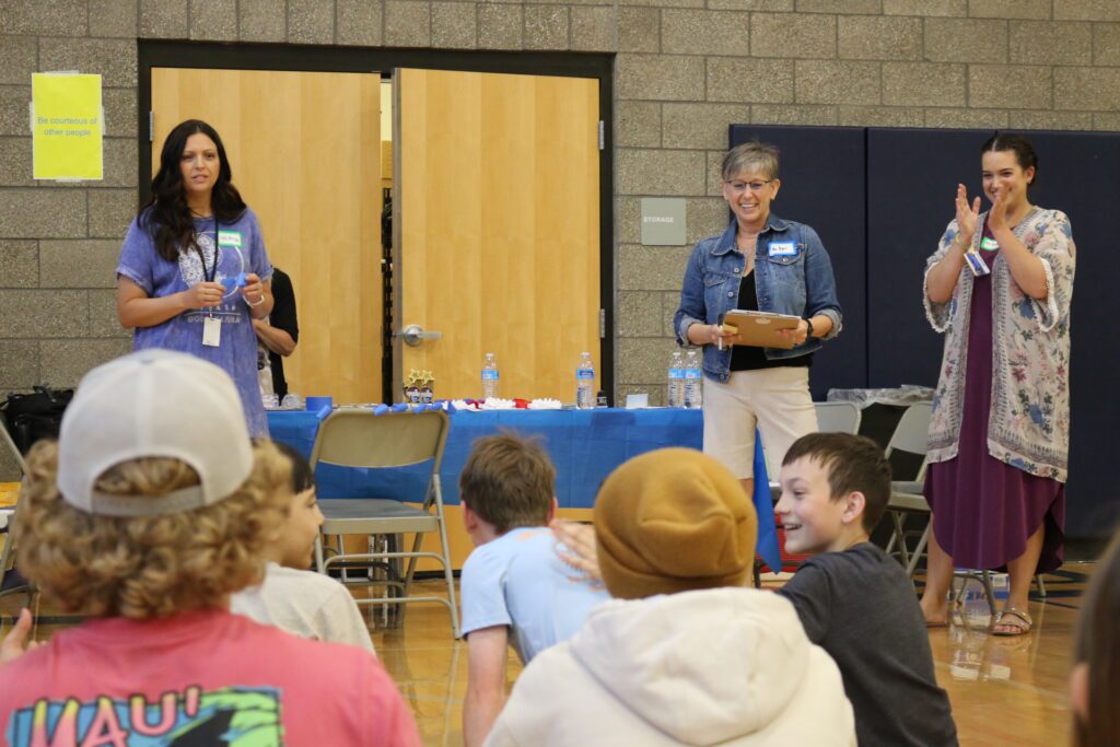 Students listen to the announcement of the fair winners