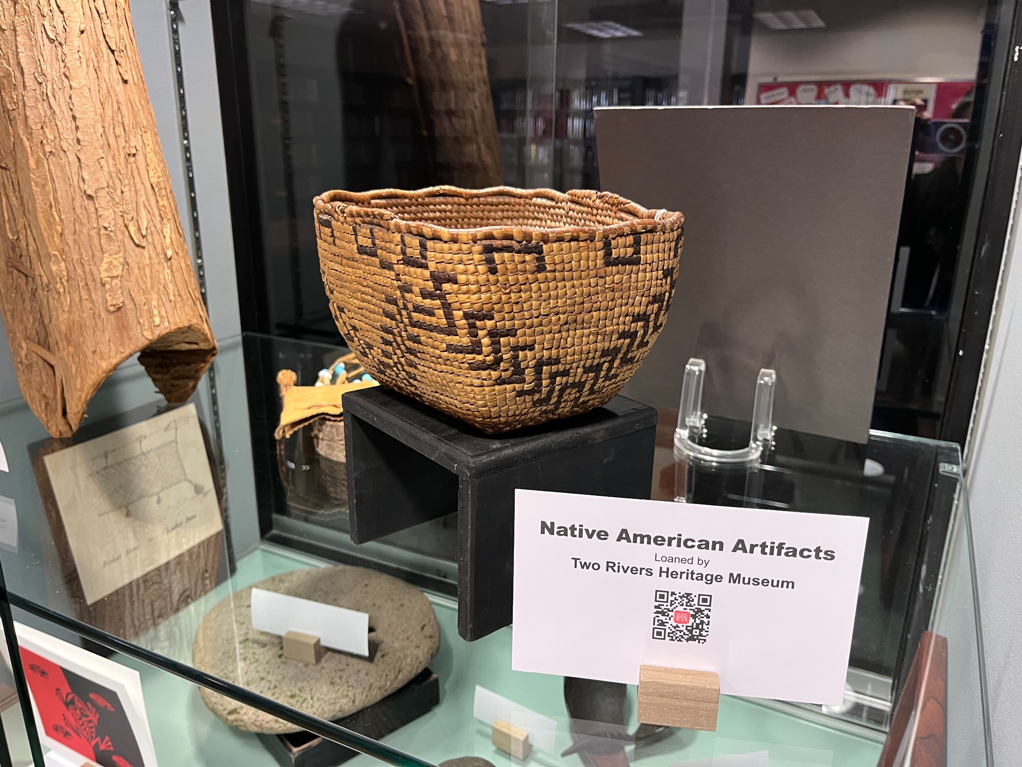 Display of loaned items from two rivers including woven basket