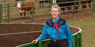 Temple Grandin leaning on railing