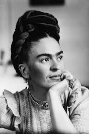 Picture of Frida Kahlo in black and white, with hand near face and rings