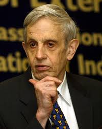 John Nash with hand on chin, in front of backdrop with words