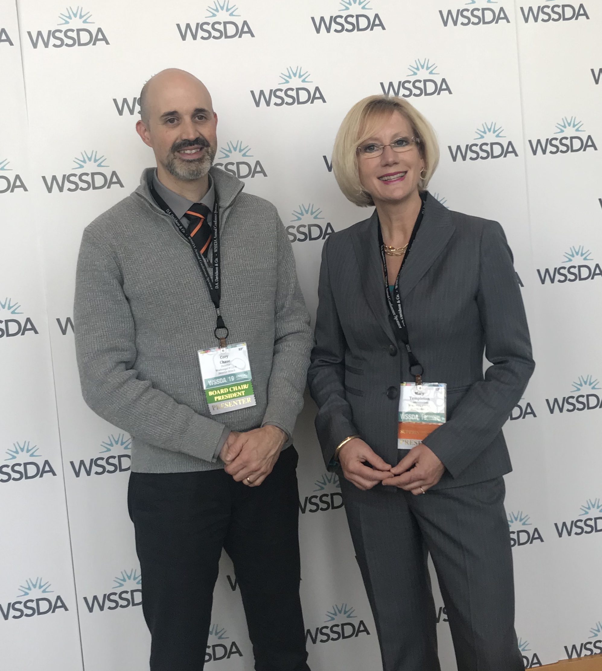 Mary Templeton and Cory Chase present at WSSDA conference Nov 2019 in front of the WSSDA banner