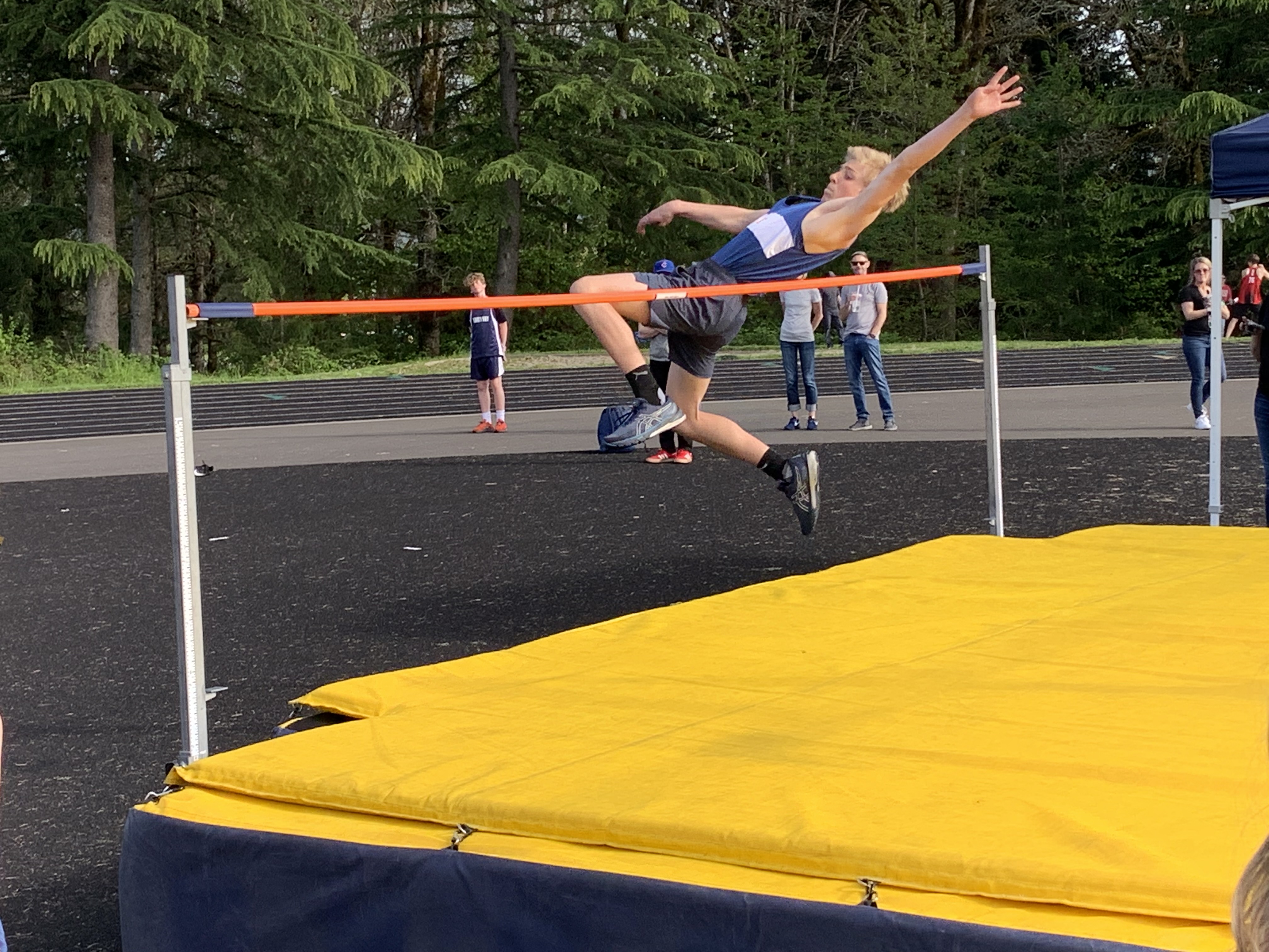 JMS Track Student-athelete jumps over high jump bar