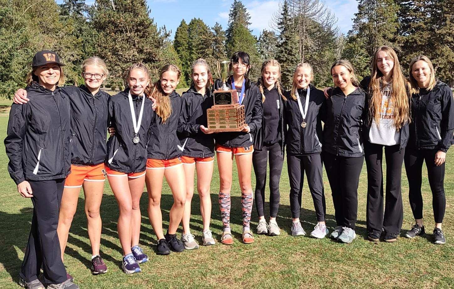 WHS Girls Cross Country runners pose with coaches and trophee