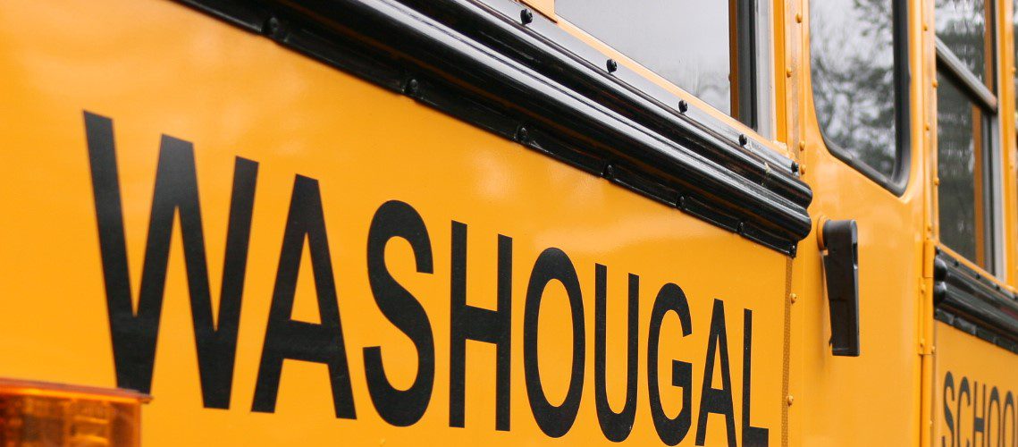 Yellow school bus from side reads "Washougal School District" in black letters.