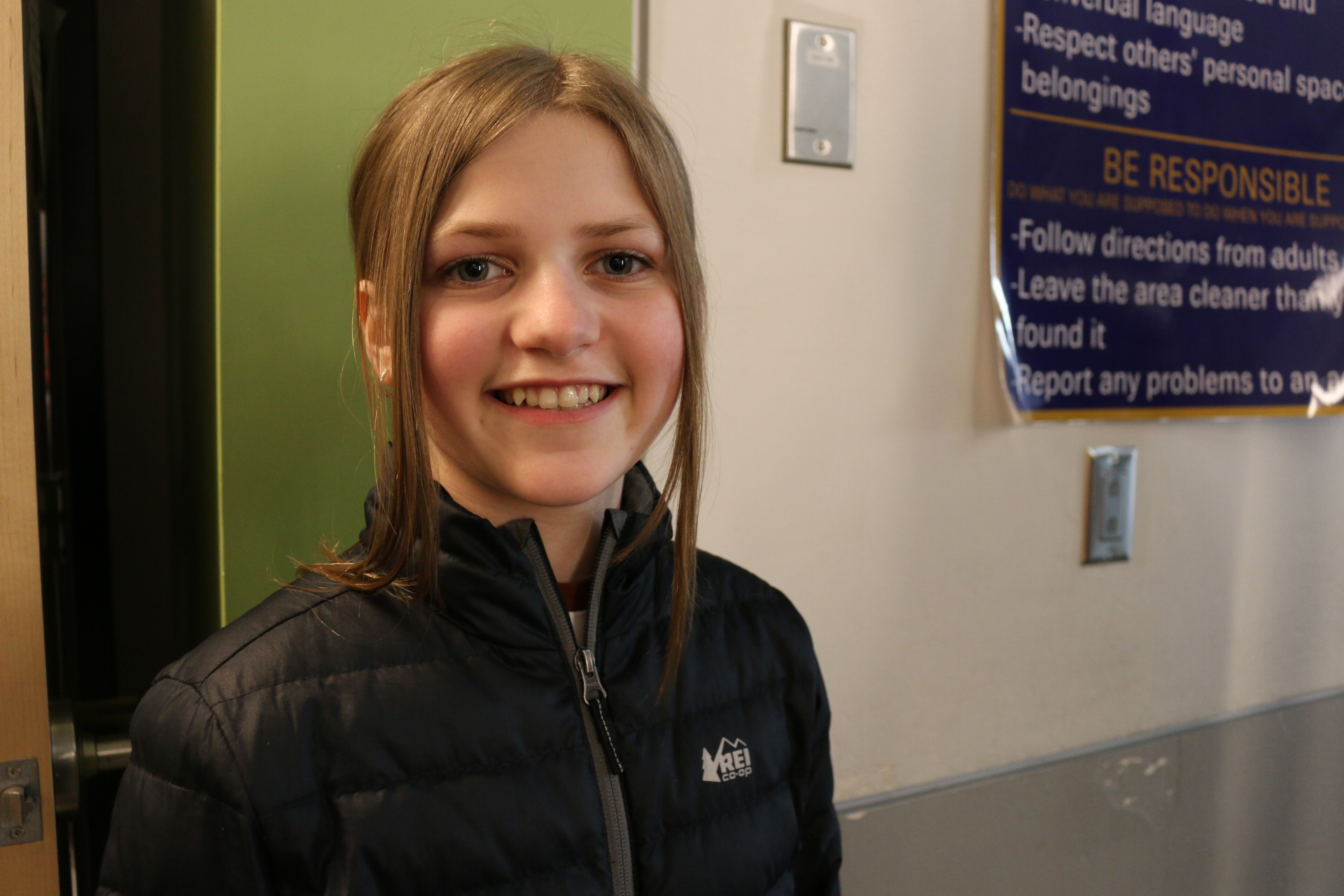 Smiling student in a hallway at the school
