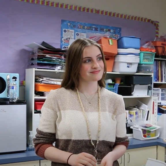 High school student visits elementary classroom for child development studies