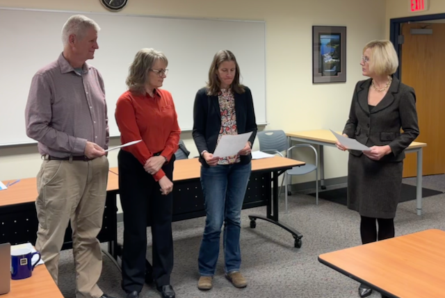 Board members are sworn in by superintendent at the board meeting