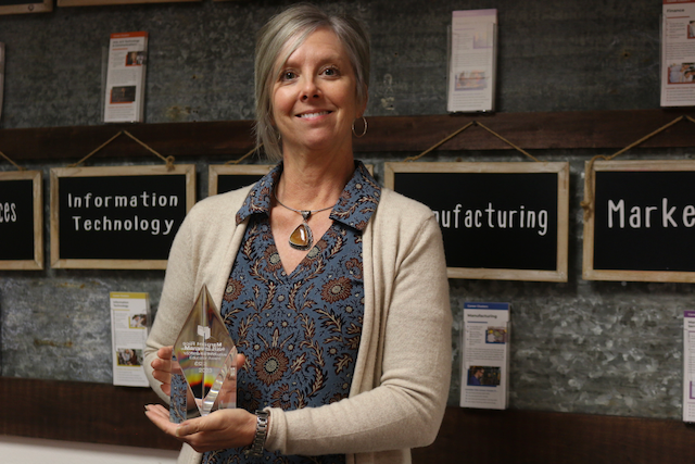 Margaret holding YouScience award in career center